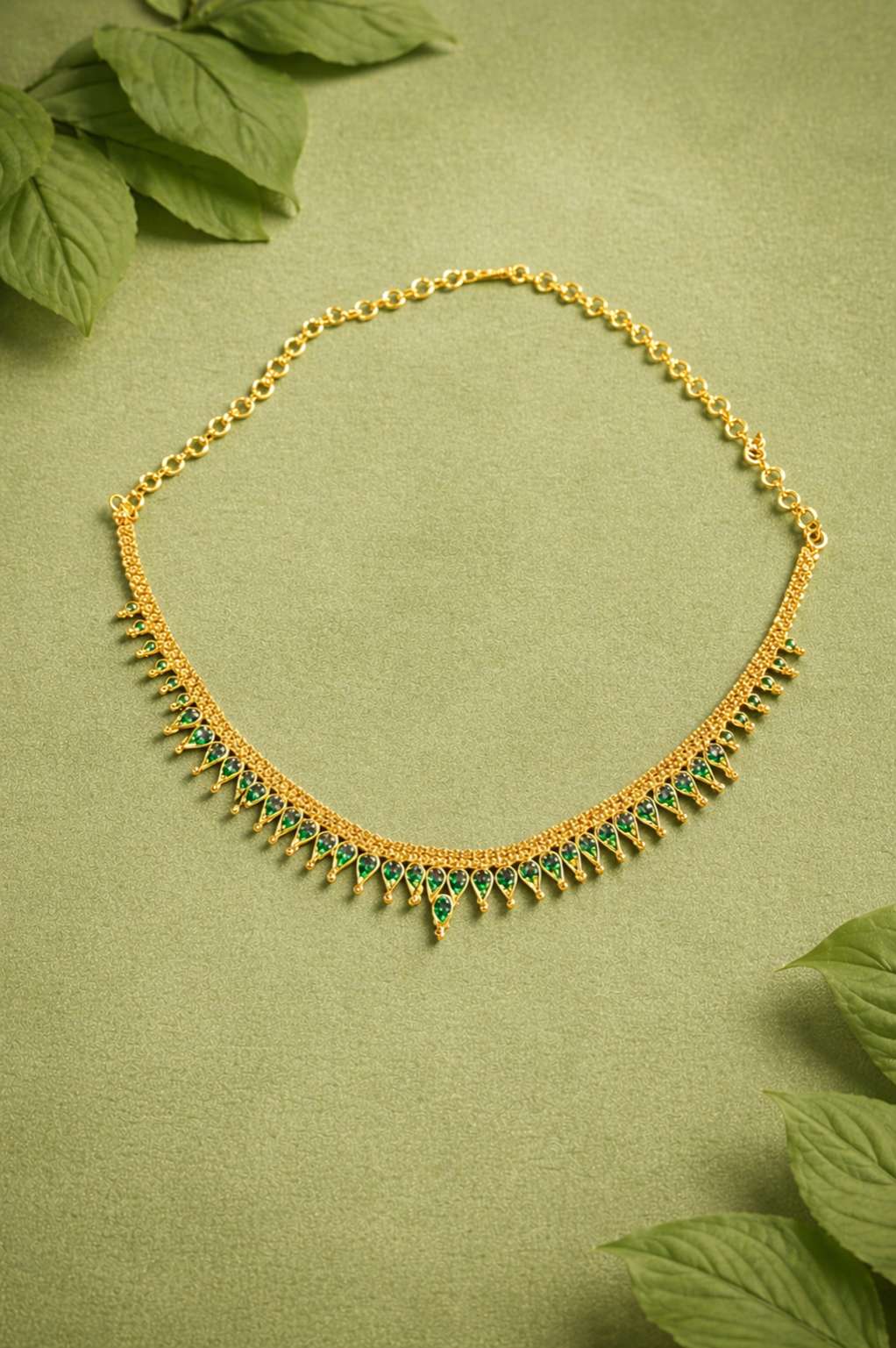 Gold necklace with green gem stones