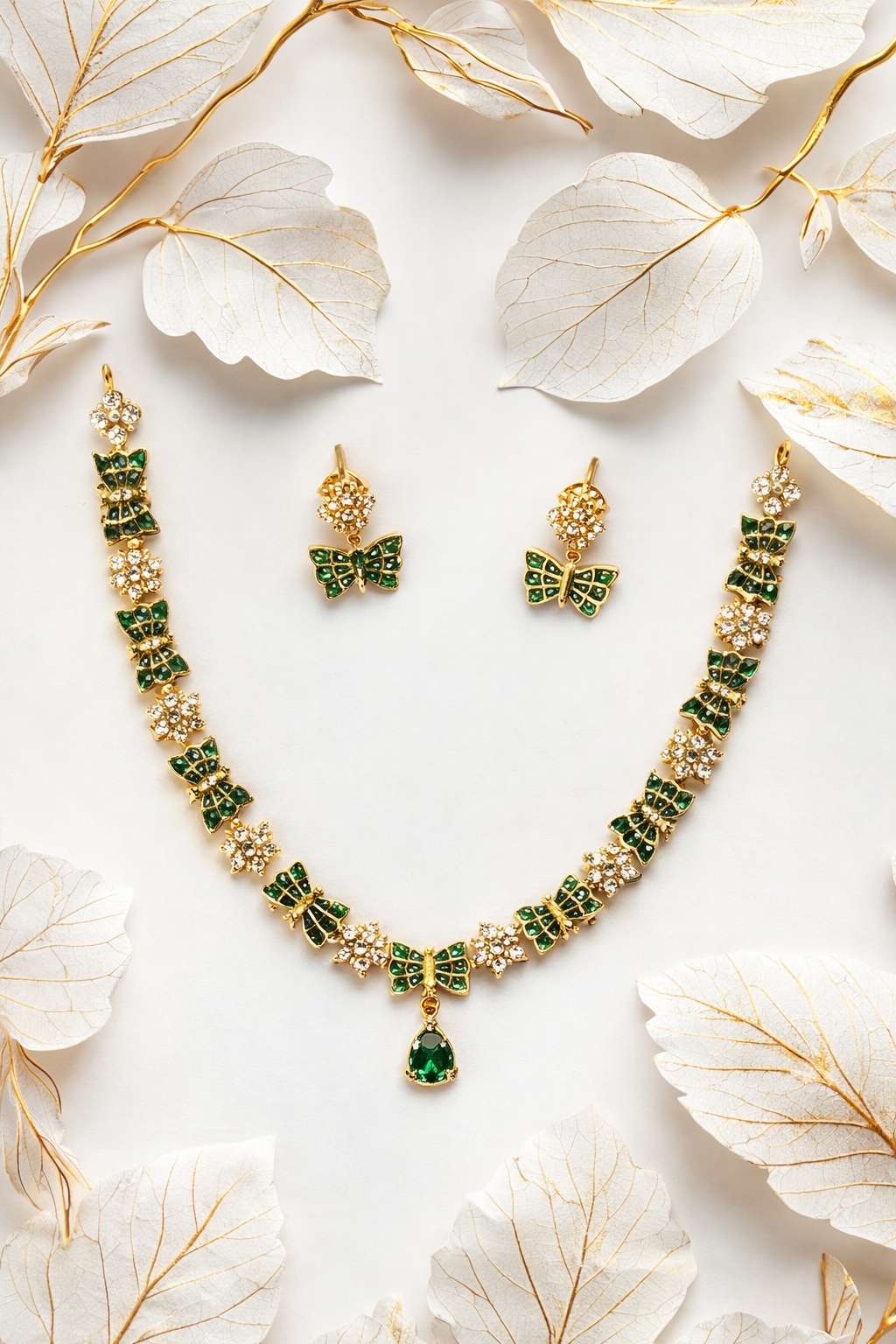 Golden butterfly jewelry with emerald accents