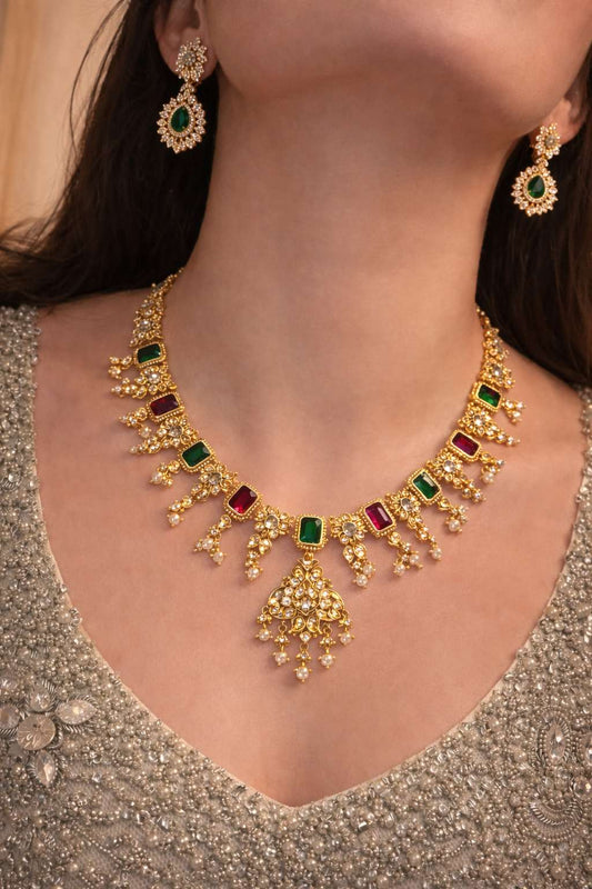 Gold jewelry with emeralds and ruby with pearls