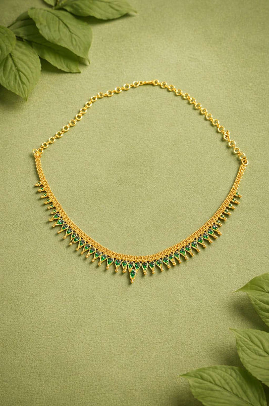 Gold necklace with green gem stones