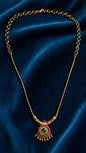 Gold pendant with emerald and ruby