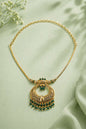 Ornate gold necklace with green gemstones